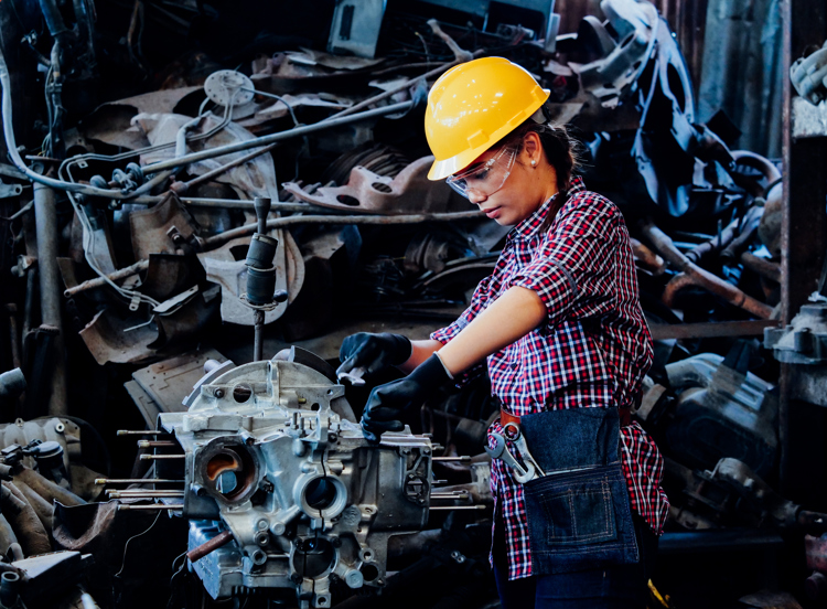 Young Asian Engineer woman working with machine in factory